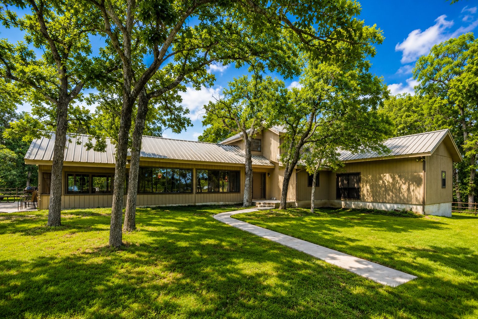 Main ranch house under mature oaks